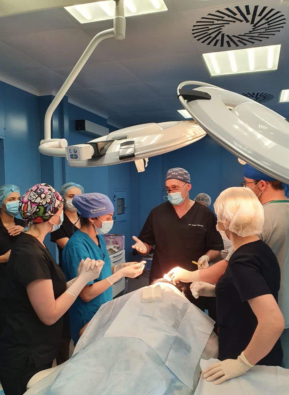 Dr. Akaki Tsilosani preparing patient for FUE procedure