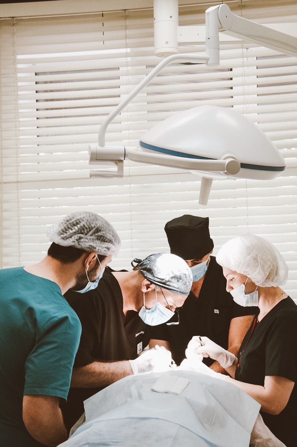 Dr. Akaki Tsilosani with team performing hair transplant